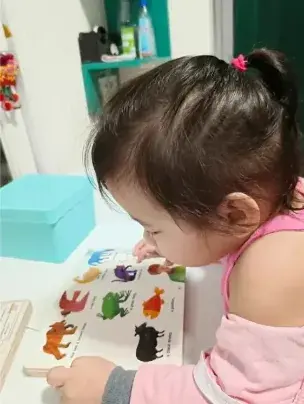 Student reading a picture book at Teacher Jan's Place