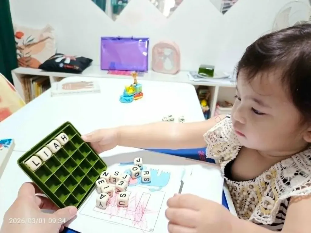 A student building words with letter tiles