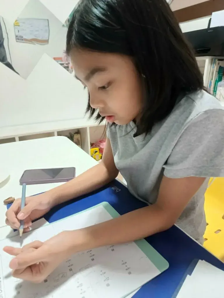 A student working on a fractions math page